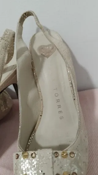 Zapatos y cartera dorados y blancos