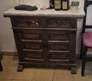 Mueble de madera tallada con tapa de mármol