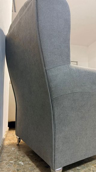 Sillón de tela gris con patas metálicas
