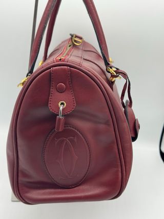 Bolso Cartier Piel burdeos.