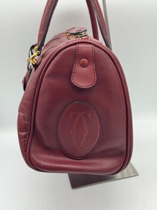 Bolso Cartier Piel burdeos.