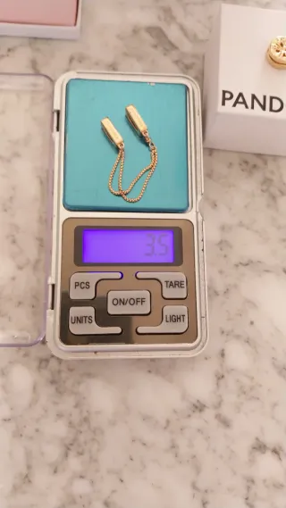 Lote Pandora Charm y Cadena de seguridad Oro Rosa