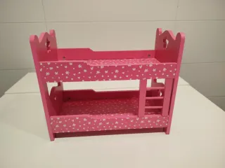 Cama de muñecas rosa con estrellas