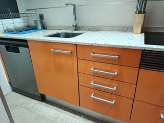 Armarios de cocina blancos y naranjas con la pica