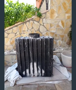 Chimenea de piedra, madera y cristal