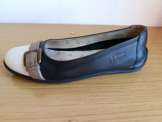 Zapatos planos negros y blancos con hebilla