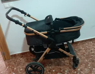 Carro de bebé negro y dorado