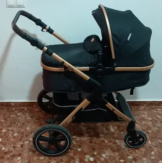 Carro de bebé negro y dorado