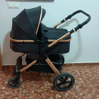 Carro de bebé negro y dorado