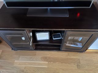 Mueble TV madera oscura con puertas de cristal