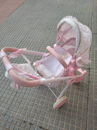 Carro de muñecas rosa con capota