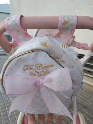 Carro de muñecas rosa con capota