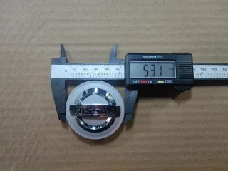Tapabujes Nissan 54mm centro rueda llanta logo