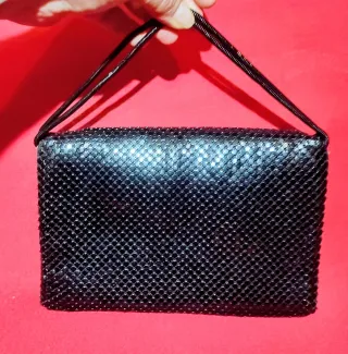 Bolso de mano negro malla metálica.