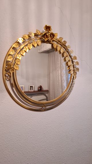 Espejo redondo dorado con decoración floral