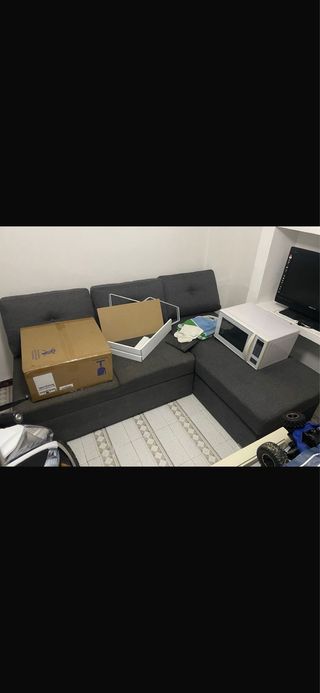 Sofá cama gris con arcón