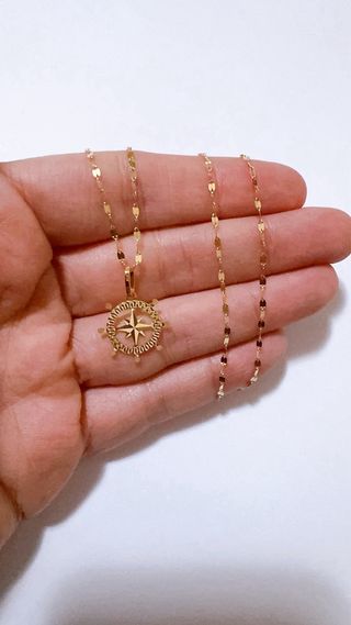 Collana con timone e rosa dei venti oro 18kt 750