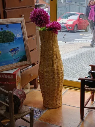 Jarrón de mimbre con flores rosas