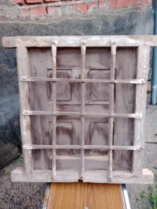 Ventana madera vieja con reja forja