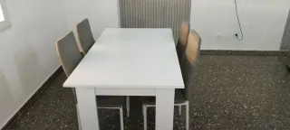 Mesa blanca con 4 sillas grises