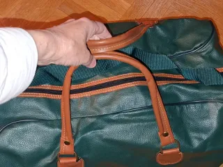 Maleta de viaje verde con asas