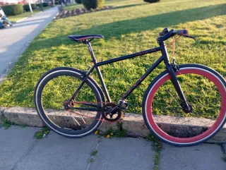 Bicicleta fixie negra con ruedas rojas
