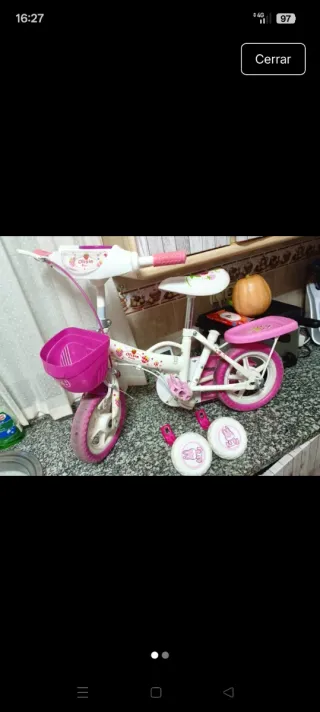 Bicicleta infantil rosa y blanca con ruedines