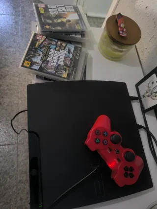 Consola PlayStation 3 Negra y un mando