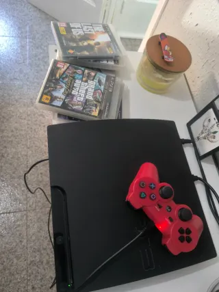 Consola PlayStation 3 Negra y un mando