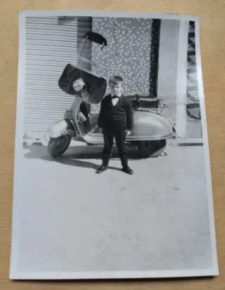 Fotografía antigua de niño y Vespa con parabrisas