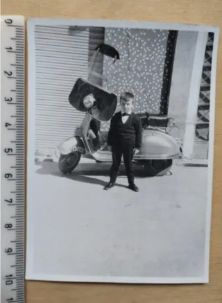 Fotografía antigua de niño y Vespa con parabrisas