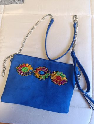 Zapatos de tacón azul a juego con la cartera.