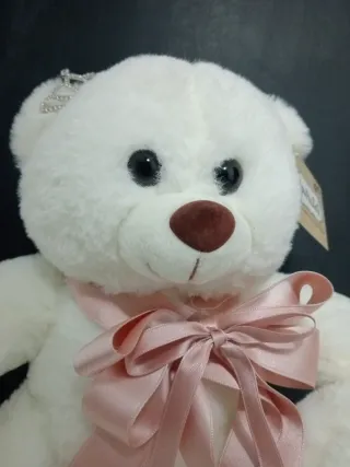 Orsacchiotto bianco con diadema e fiocco