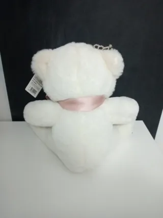 Orsacchiotto bianco con diadema e fiocco