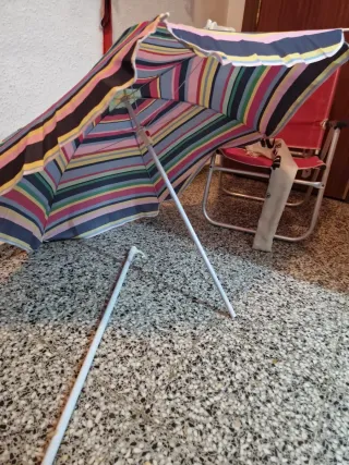 Silla plegable playa rosa y sombrilla