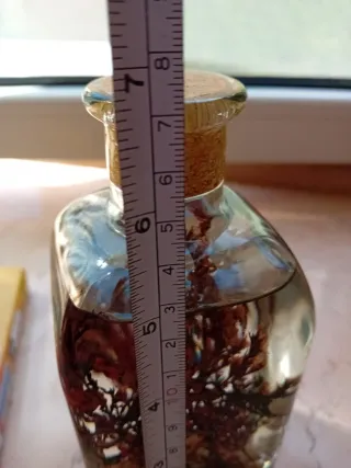 Candela decorativa con conchiglie e rami di fiore