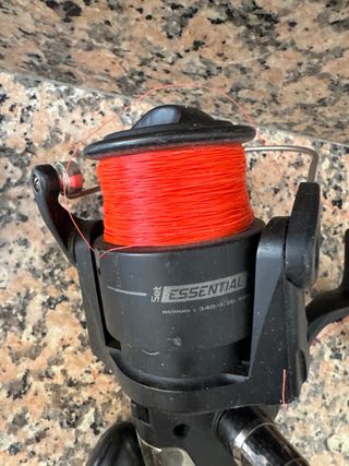 Due carrelli da pesca neri con filo rosso