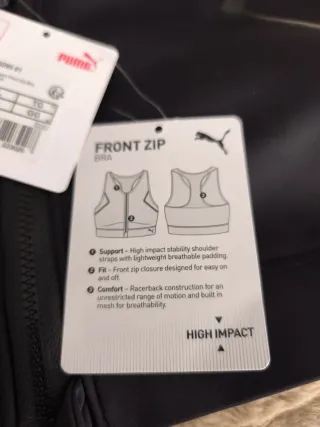 Top deportivo Puma negro con cremallera frontal