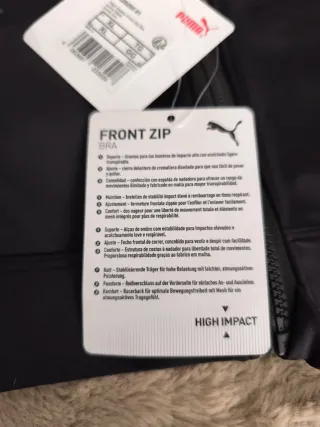 Top deportivo Puma negro con cremallera frontal