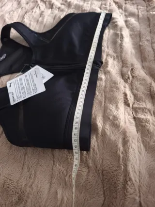 Top deportivo Puma negro con cremallera frontal