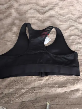 Top deportivo Puma negro con cremallera frontal