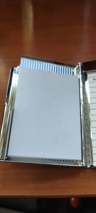 Agenda de teléfono plateada años 60