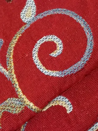 Copriletto rosso con decoro floreale.