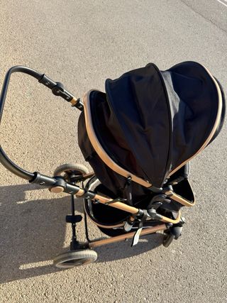 Carrito de bebé negro y dorado desde recien nacido