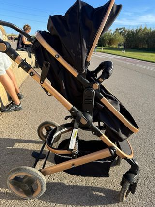 Carrito de bebé negro y dorado desde recien nacido