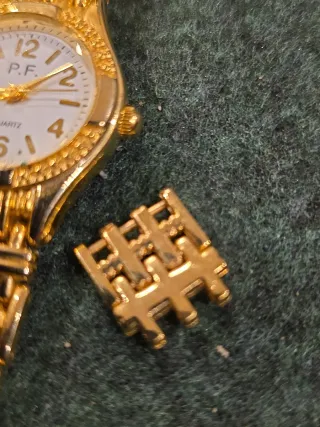 Mini reloj P.F. dorado