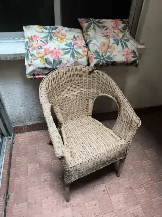 Sillón de mimbre con cojines florales