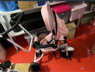 Triciclo infantil rosa con capota