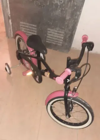 Bicicleta infantil rosa con ruedines
