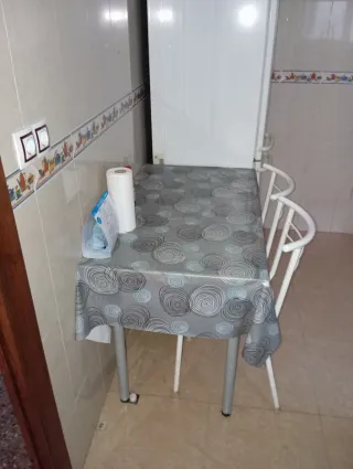 Mesa de cocina con mantel y silla